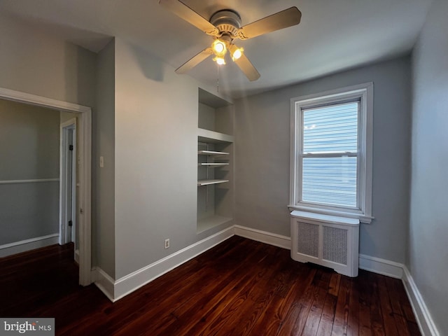 453 Belgrade St, Philadelphia, PA 19125 - unfurnished room featuring radiator heating unit, dark wood finished floors, built in shelves, and ceiling fan
