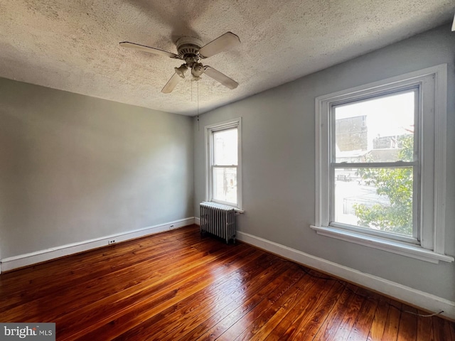 453 Belgrade St, Philadelphia, PA 19125 - empty room with radiator, wood-type flooring, a textured ceiling, plenty of natural light, and ceiling fan