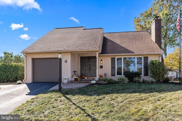 4 Carousel Dr, Telford, PA 18969 - view of front of house with an attached garage, a chimney, a shingled roof, and driveway