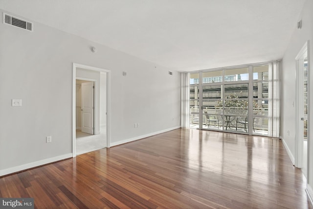 157 Fleet St Unit 303, National Harbor, MD 20745 - spare room featuring wood finished floors and a wall of windows