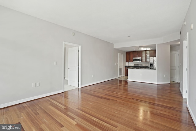 157 Fleet St Unit 303, National Harbor, MD 20745 - unfurnished living room featuring wood finished floors and baseboards