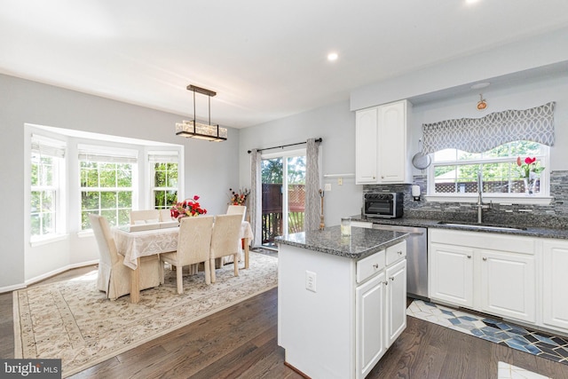 8226 Bates Rd, Lorton, VA 22079 - kitchen with dishwasher, a kitchen island, white cabinetry, tasteful backsplash, and dark wood finished floors