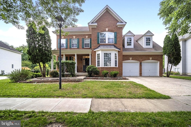 2110 Green Ginger Cir, Accokeek, MD 20607 - view of front of home featuring brick siding, concrete driveway, a front lawn, a porch, and an attached garage