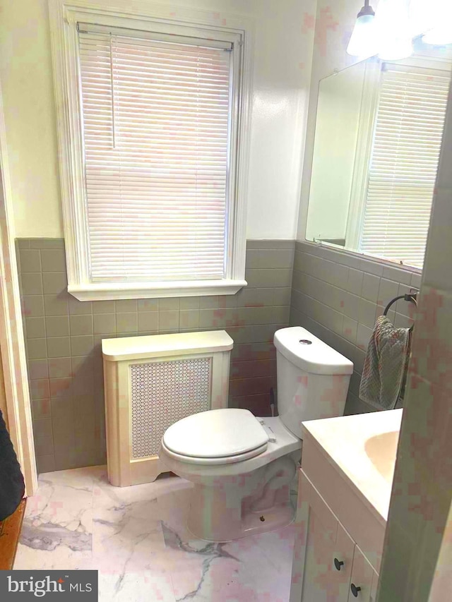 1021 Serrill Ave, Lansdowne, PA 19050 - half bath with radiator heating unit, tile walls, vanity, a wainscoted wall, and marble finish floors