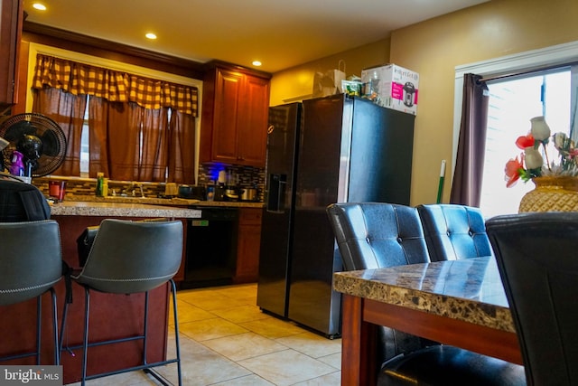 1021 Serrill Ave, Lansdowne, PA 19050 - kitchen with refrigerator with ice dispenser, dishwasher, decorative backsplash, light tile patterned floors, and recessed lighting