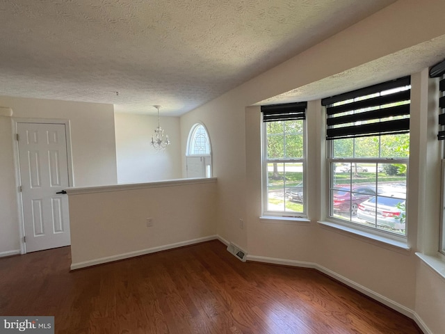 4407 Stanford Ct, Owings Mills, MD 21117 - empty room featuring a textured ceiling, a chandelier, and wood finished floors