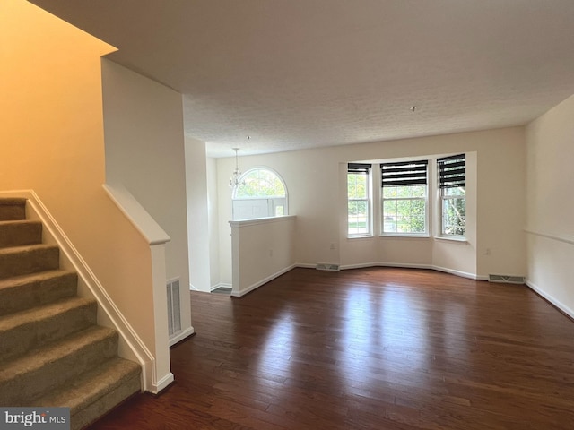 4407 Stanford Ct, Owings Mills, MD 21117 - unfurnished living room featuring dark wood-style flooring, stairs, and a chandelier