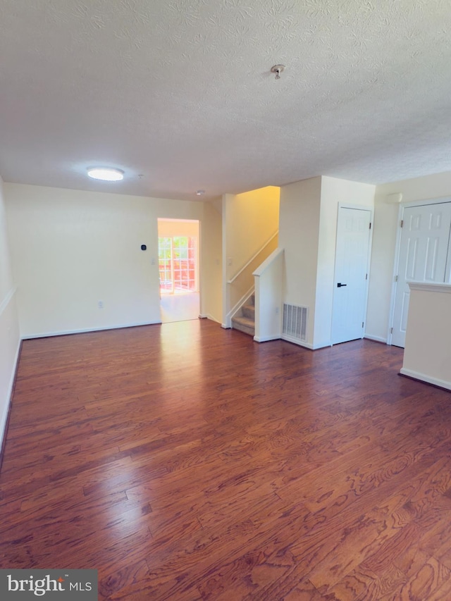 4407 Stanford Ct, Owings Mills, MD 21117 - unfurnished living room featuring wood finished floors, stairs, and a textured ceiling