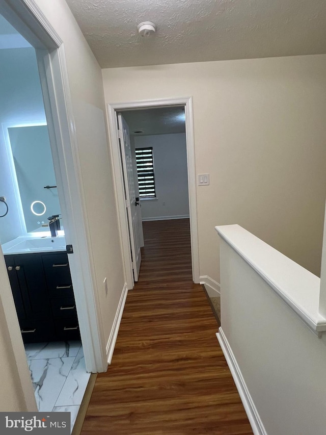 4407 Stanford Ct, Owings Mills, MD 21117 - hall featuring an upstairs landing, wood finished floors, and a textured ceiling