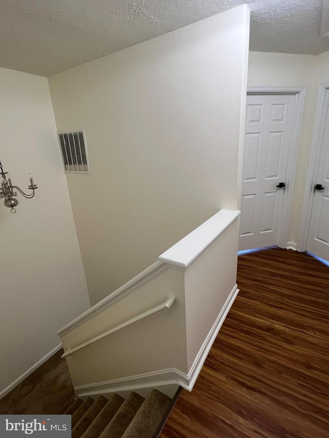 4407 Stanford Ct, Owings Mills, MD 21117 - stairs featuring wood finished floors and a textured ceiling
