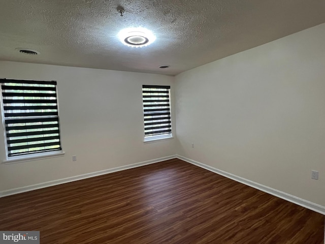 4407 Stanford Ct, Owings Mills, MD 21117 - spare room with dark wood finished floors and a textured ceiling