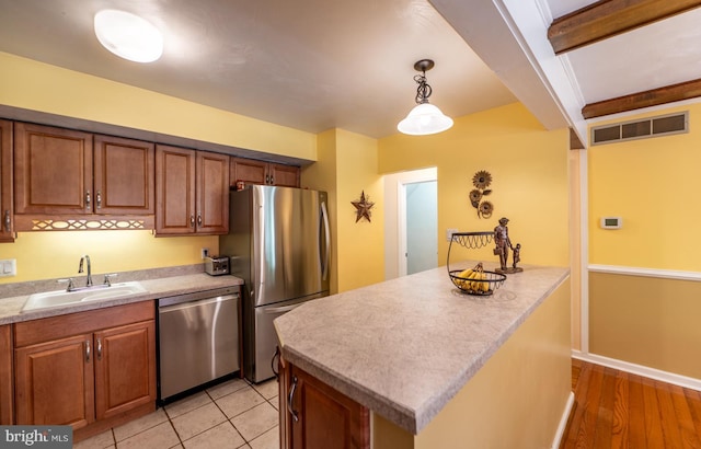 118 Roboda Blvd, Royersford, PA 19468 - kitchen with stainless steel appliances, brown cabinetry, and light countertops