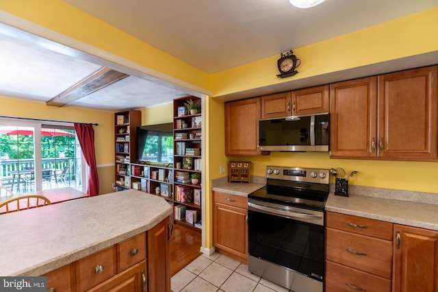 118 Roboda Blvd, Royersford, PA 19468 - kitchen with appliances with stainless steel finishes, brown cabinetry, light countertops, and light tile patterned floors