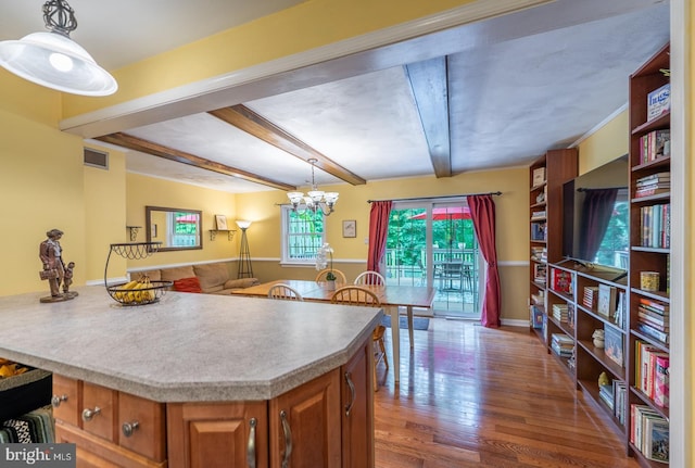 118 Roboda Blvd, Royersford, PA 19468 - kitchen with brown cabinets, wood finished floors, beam ceiling, pendant lighting, and a chandelier