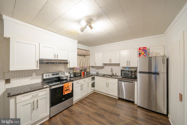 231 N Penn St, West Chester, PA 19380 - kitchen featuring stainless steel appliances, backsplash, white cabinetry, and dark stone counters