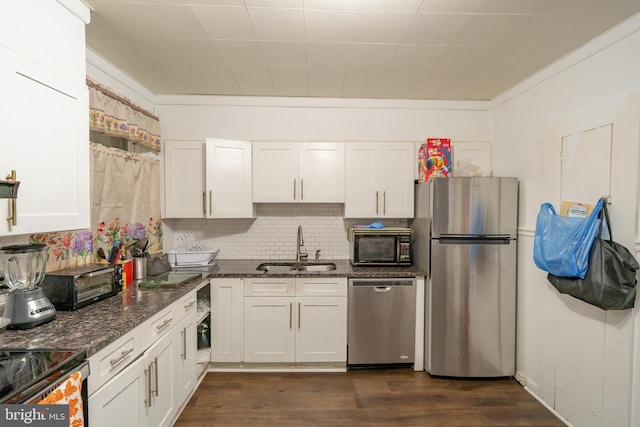 231 N Penn St, West Chester, PA 19380 - kitchen with stainless steel appliances, white cabinets, backsplash, crown molding, and dark wood finished floors