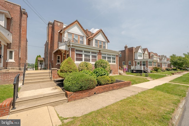 231 N Penn St, West Chester, PA 19380 - view of front of home with brick siding, a residential view, and a front yard