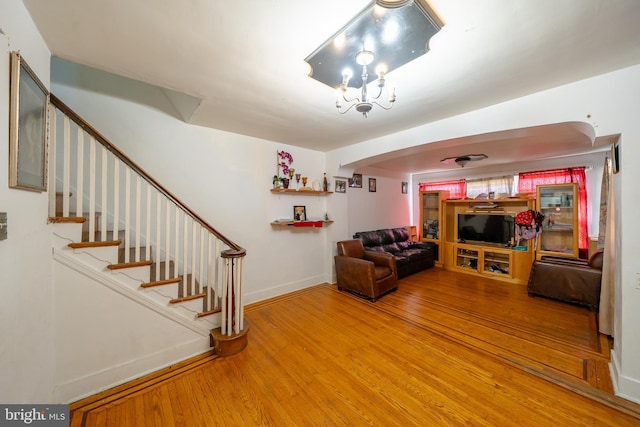 231 N Penn St, West Chester, PA 19380 - living room featuring wood finished floors, stairway, and arched walkways