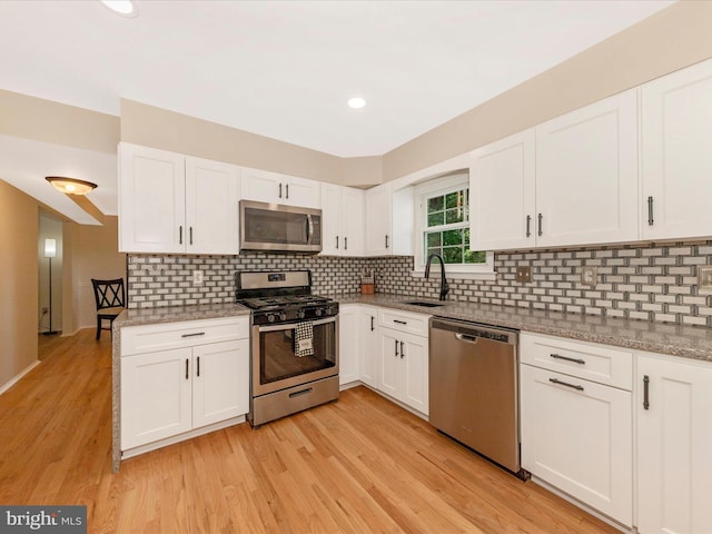 24129 Pecan Grove Ln, Gaithersburg, MD 20882 - kitchen with stainless steel appliances, white cabinetry, light wood-style floors, light stone countertops, and recessed lighting