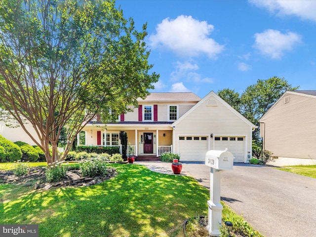 24129 Pecan Grove Ln, Gaithersburg, MD 20882 - traditional-style house with a garage, driveway, a porch, and a front yard