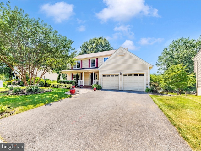 24129 Pecan Grove Ln, Gaithersburg, MD 20882 - view of front facade with a garage, asphalt driveway, a porch, and a front yard