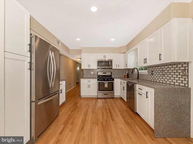 24129 Pecan Grove Ln, Gaithersburg, MD 20882 - kitchen with appliances with stainless steel finishes, light wood-style flooring, white cabinets, and recessed lighting