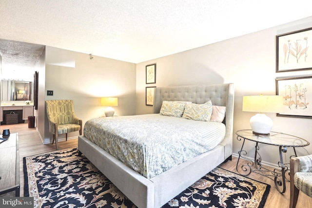 15101 Interlachen Dr Unit 1-126, Silver Spring, MD 20906 - bedroom with wood finished floors and a textured ceiling