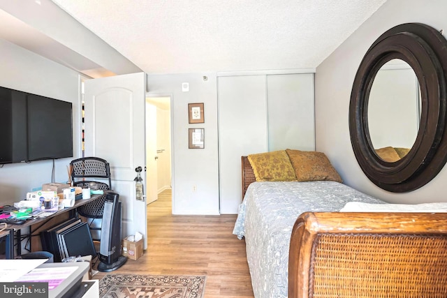 15101 Interlachen Dr Unit 1-126, Silver Spring, MD 20906 - bedroom featuring wood finished floors, a closet, and a textured ceiling