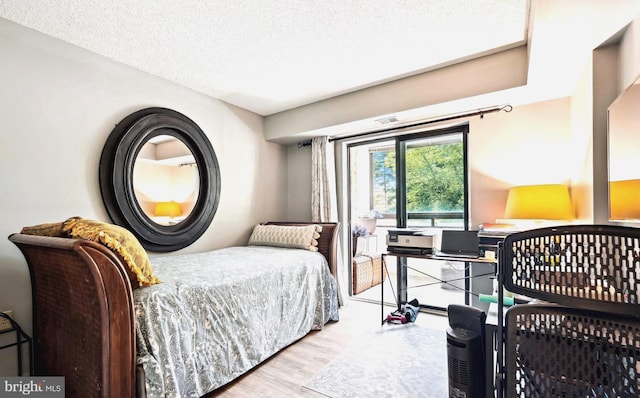 15101 Interlachen Dr Unit 1-126, Silver Spring, MD 20906 - bedroom with wood finished floors and a textured ceiling