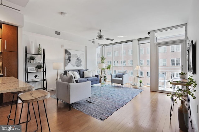 1025 1st St SE Unit 809, Washington, DC 20003 - living room featuring floor to ceiling windows, a ceiling fan, and wood finished floors
