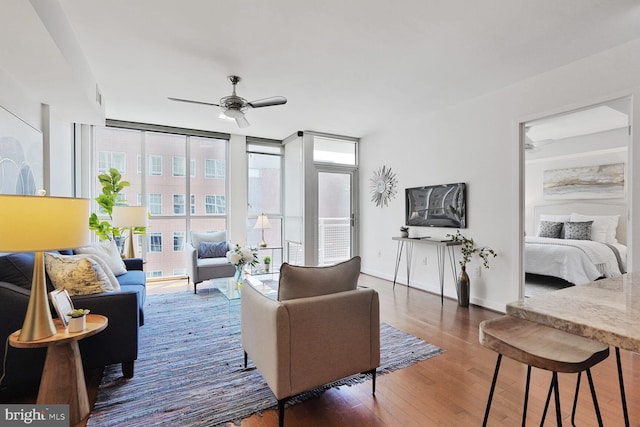 1025 1st St SE Unit 809, Washington, DC 20003 - living room with a ceiling fan, wood finished floors, and floor to ceiling windows