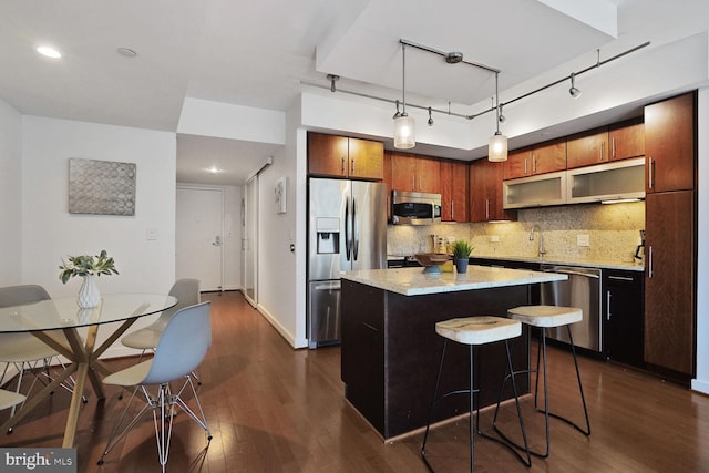 1025 1st St SE Unit 809, Washington, DC 20003 - kitchen with appliances with stainless steel finishes, dark wood-style flooring, tasteful backsplash, and a center island