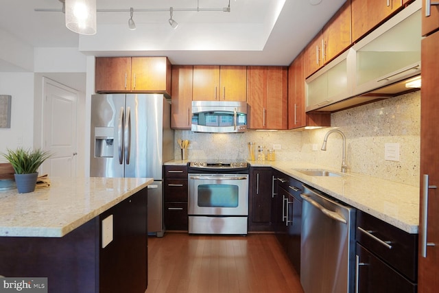 1025 1st St SE Unit 809, Washington, DC 20003 - kitchen featuring appliances with stainless steel finishes, decorative backsplash, dark wood-type flooring, and light stone countertops