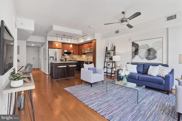 1025 1st St SE Unit 809, Washington, DC 20003 - living room featuring rail lighting, dark wood-style flooring, and ceiling fan
