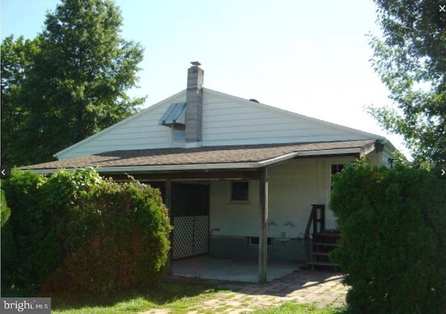 2130 Lincoln Ave, Reading, PA 19609 - back of property with a patio area and a chimney