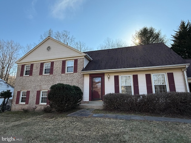 12130 Ambleside Dr, Potomac, MD 20854 - view of front facade with brick siding, roof with shingles, and a front lawn