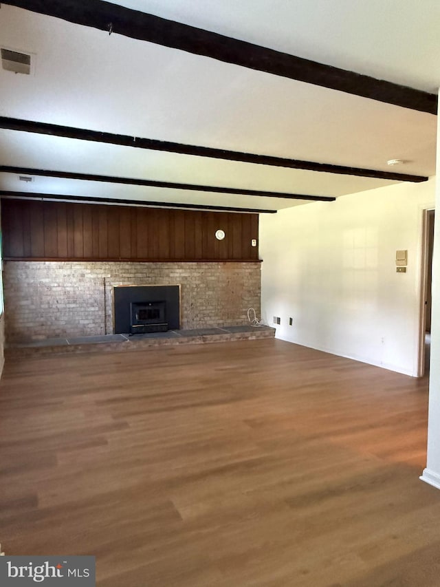 12130 Ambleside Dr, Potomac, MD 20854 - unfurnished living room with wood finished floors, a fireplace, and beam ceiling