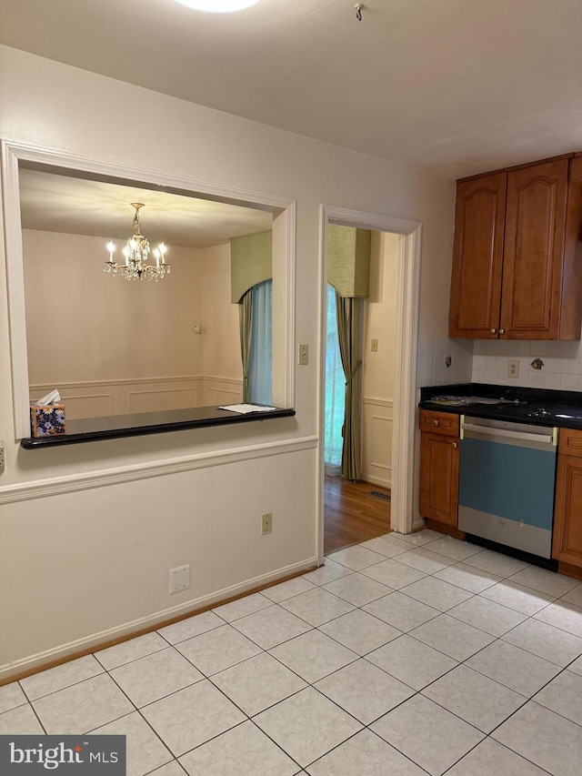 12130 Ambleside Dr, Potomac, MD 20854 - kitchen featuring dishwasher, light tile patterned floors, brown cabinets, and dark countertops