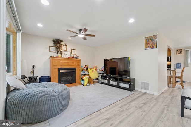 4030 Bensalem Blvd, Bensalem, PA 19020 - living room featuring a glass covered fireplace, light wood-style flooring, ceiling fan, and recessed lighting