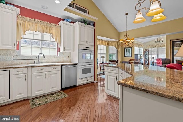 945 Hamilton Way, Warwick, PA 18974 - kitchen featuring dishwasher, white double oven, a chandelier, white cabinets, and high vaulted ceiling