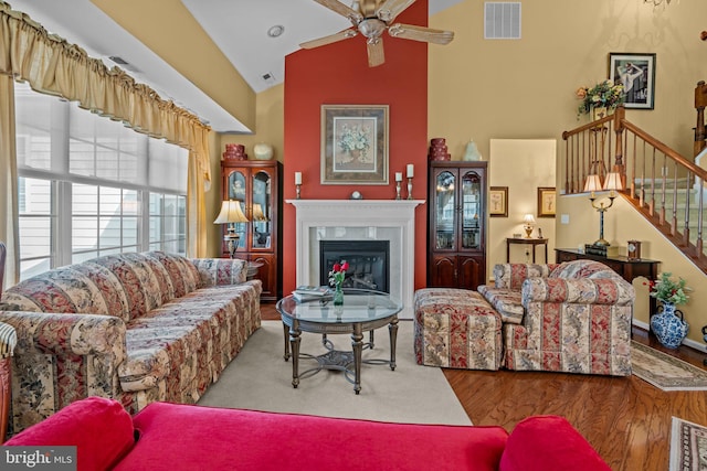 945 Hamilton Way, Warwick, PA 18974 - living room with ceiling fan, stairway, a glass covered fireplace, high vaulted ceiling, and wood finished floors