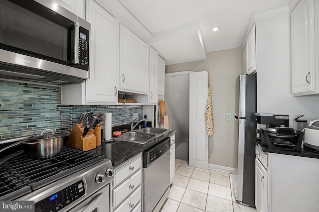 808 Olmstead Rd, Baltimore, MD 21208 - kitchen with appliances with stainless steel finishes, white cabinetry, backsplash, recessed lighting, and light tile patterned floors