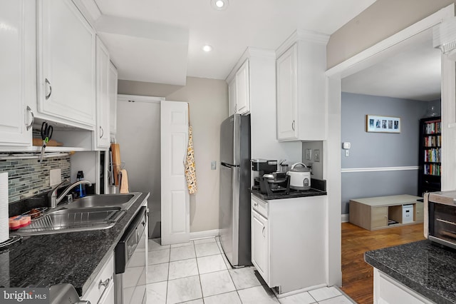 808 Olmstead Rd, Baltimore, MD 21208 - kitchen with appliances with stainless steel finishes, white cabinets, decorative backsplash, recessed lighting, and dark stone counters