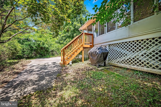 808 Olmstead Rd, Baltimore, MD 21208 - wooden deck with area for grilling, a sunroom, and stairs