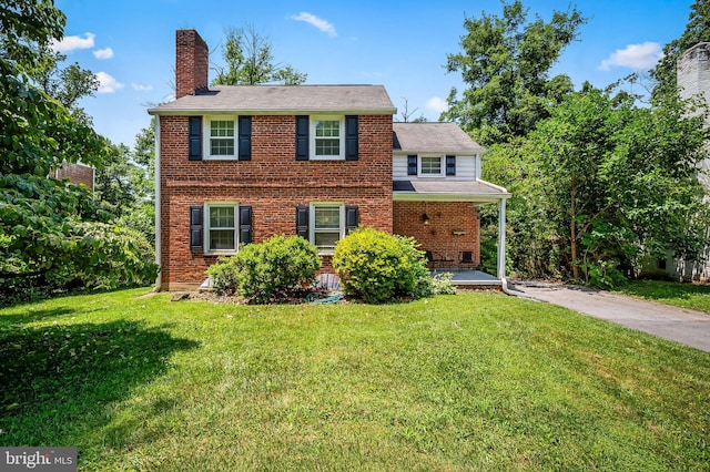 808 Olmstead Rd, Baltimore, MD 21208 - view of front of property featuring a chimney, a front lawn, brick siding, a porch, and roof with shingles
