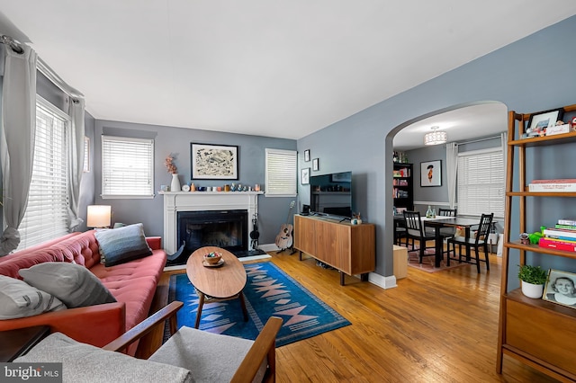 808 Olmstead Rd, Baltimore, MD 21208 - living area with arched walkways, wood finished floors, and a glass covered fireplace