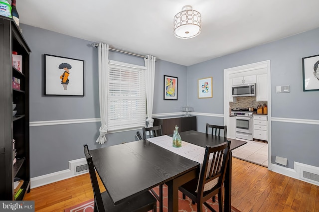 808 Olmstead Rd, Baltimore, MD 21208 - dining space with light wood-type flooring and baseboards