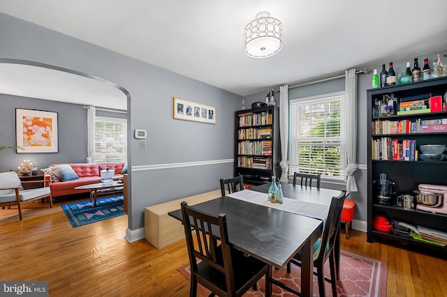 808 Olmstead Rd, Baltimore, MD 21208 - dining room featuring healthy amount of natural light, wood finished floors, and arched walkways