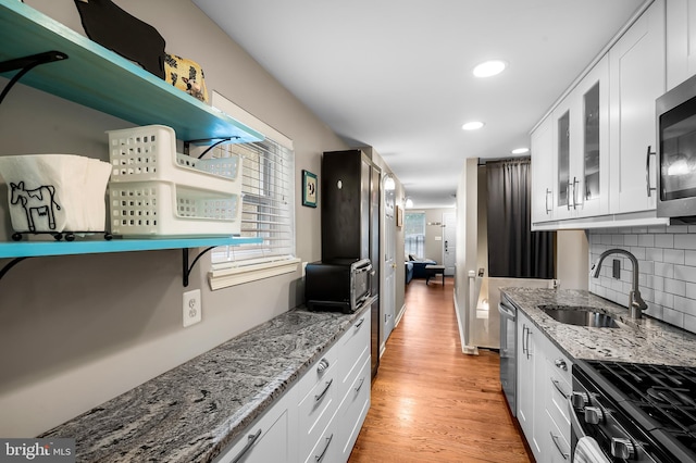 2503 Eastern Ave, Baltimore, MD 21224 - kitchen featuring white cabinetry, light stone counters, glass insert cabinets, and recessed lighting