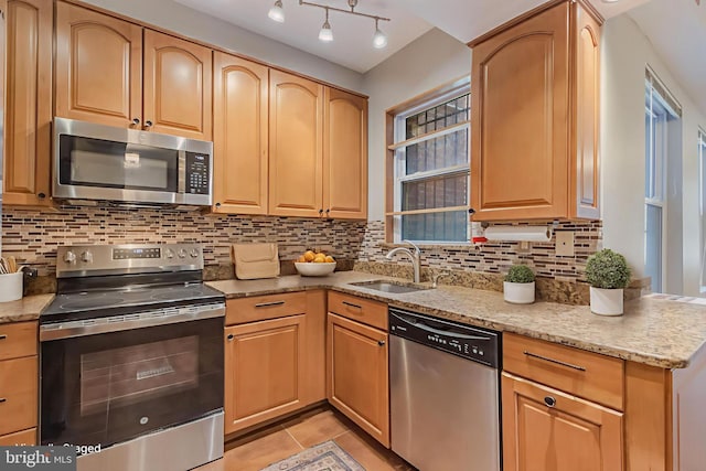 1458 Columbia Rd NW Unit 109, Washington, DC 20009 - kitchen with stainless steel appliances, light stone countertops, backsplash, light tile patterned flooring, and light brown cabinets